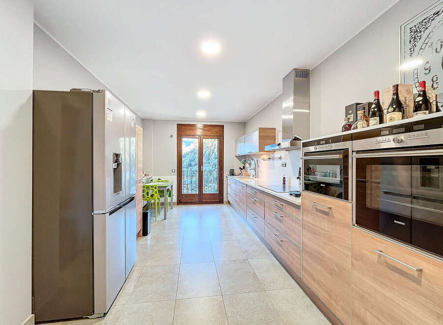This stunning kitchen boasts modern appliances and ample counter space, perfect for culinary enthusiasts.