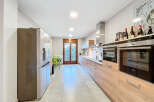 This stunning kitchen boasts modern appliances and ample counter space, perfect for culinary enthusiasts.