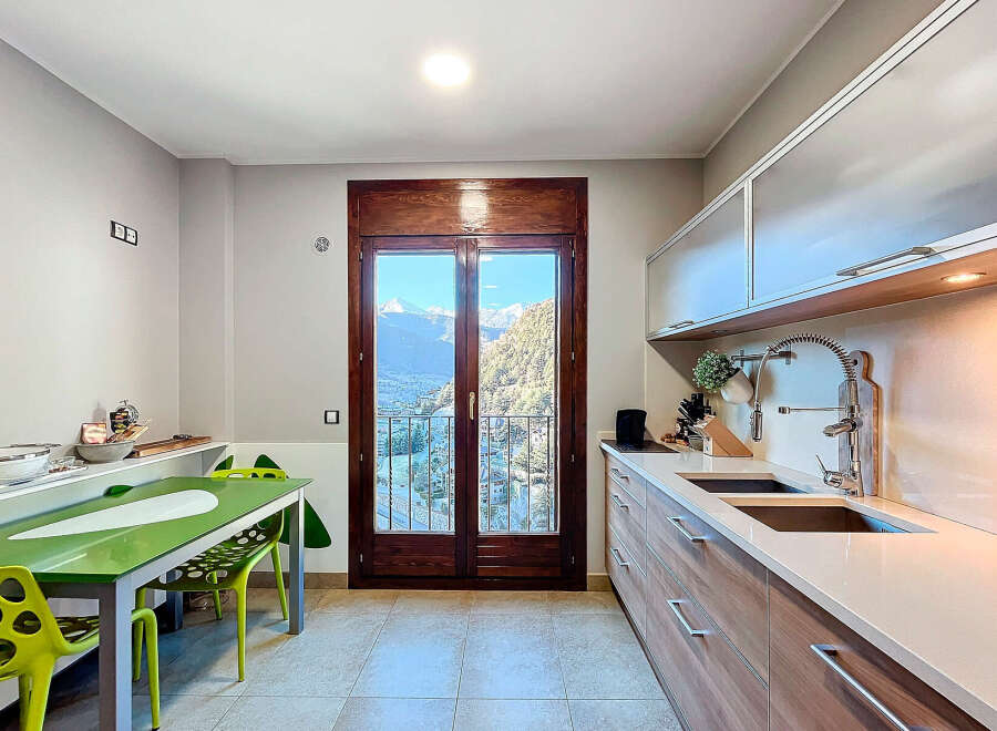 This stunning kitchen boasts breathtaking mountain views, perfect for those who appreciate natural beauty.