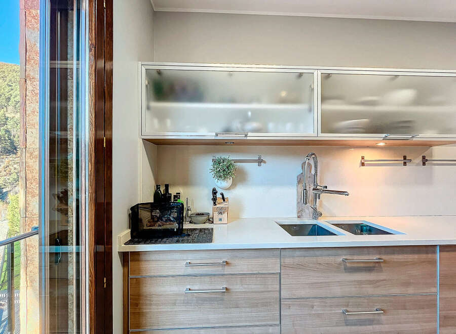 Discover modern living in this stunning kitchen! Featuring sleek cabinetry, a double sink, and a stylish faucet, this space is perfect for culinary enthusiasts.