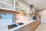 Modern kitchen design featuring sleek cabinetry, stainless steel appliances, and a pristine countertop.