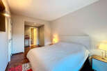 Discover the tranquility of this inviting bedroom, featuring a comfortable bed and a serene ambiance.