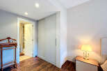 Step into this inviting bedroom, featuring a spacious closet and a well-lit interior.