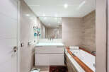 This modern bathroom features a sleek design with a luxurious soaking tub and a stylish vanity.