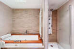 Indulge in luxury with this stunning bathroom featuring a sleek jacuzzi and a separate shower.