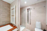 This modern bathroom features a sleek design with neutral tones and high-end finishes.