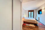 Discover the tranquility of this inviting bedroom, featuring a cozy bed and a stunning view.