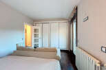 Discover this inviting bedroom featuring a comfortable bed and a stylish sofa.