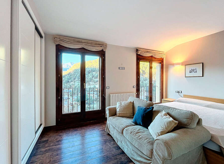 Experience the tranquility of this stunning bedroom with breathtaking mountain views.