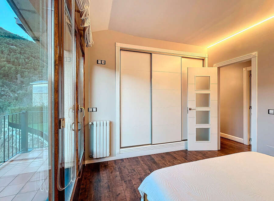 Experience luxury living in this stunning property featuring a spacious bedroom with a private balcony.