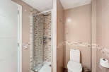 Step into this modern bathroom featuring a sleek glass shower enclosure and stylish tile work.