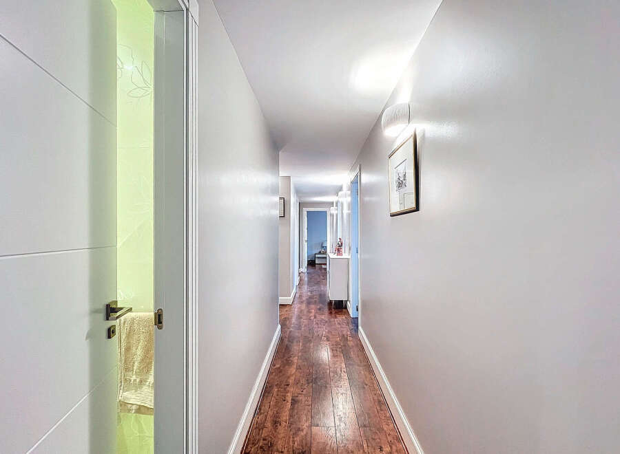 Step into this inviting hallway, showcasing a seamless blend of modern design and warm ambiance.