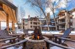 Enjoy the warmth of a cozy fire pit surrounded by comfortable seating, perfect for relaxing evenings.