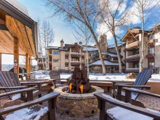 Enjoy the warmth of a cozy fire pit surrounded by comfortable seating, perfect for relaxing evenings.