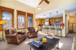 This stunning property boasts a cozy living area with two comfortable leather armchairs, perfect for relaxing after a long day.