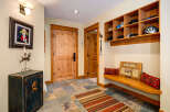 Step into this inviting entryway, showcasing a blend of rustic charm and modern functionality.