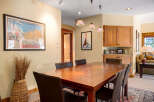 This stunning dining area features a beautiful wooden table, perfect for hosting gatherings.