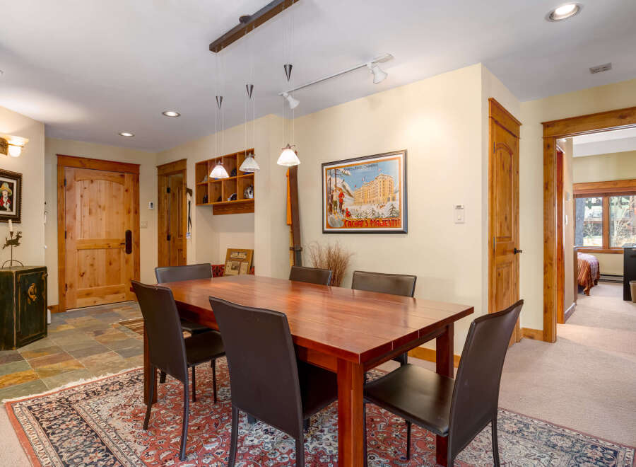 Step into this inviting dining room, showcasing a beautiful wooden dining table and comfortable seating.