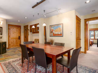 Step into this inviting dining room, showcasing a beautiful wooden dining table and comfortable seating.