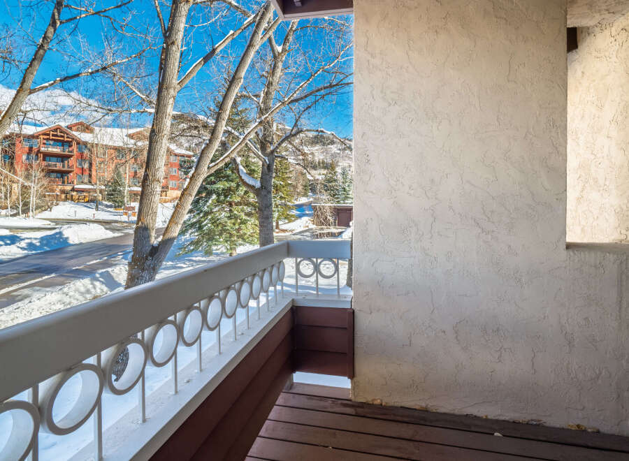 Enjoy breathtaking views from this charming balcony overlooking a winter wonderland.