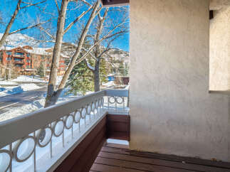 Enjoy breathtaking views from this charming balcony overlooking a winter wonderland.