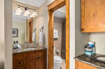 Step into this beautifully designed bathroom, featuring a warm wooden vanity and a stunning granite countertop.