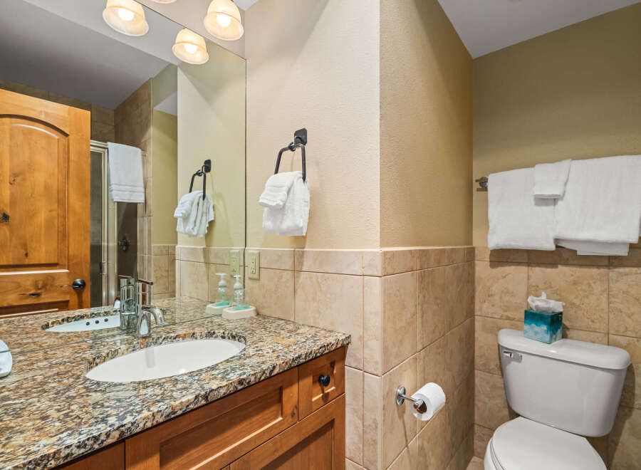 This stunning bathroom features a beautiful granite countertop and a stylish sink, perfect for your daily routines.