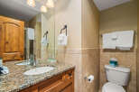 This stunning bathroom features a beautiful granite countertop and a stylish sink, perfect for your daily routines.