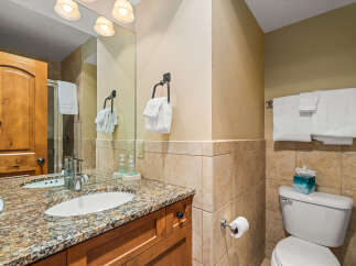 This stunning bathroom features a beautiful granite countertop and a stylish sink, perfect for your daily routines.