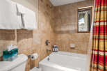 Step into a luxurious bathroom featuring a pristine white bathtub and elegant tile work.