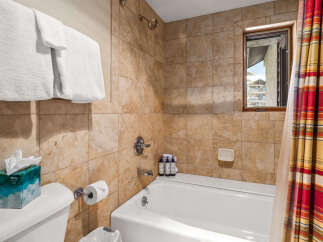 Step into a luxurious bathroom featuring a pristine white bathtub and elegant tile work.