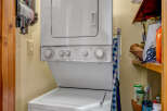 Discover the convenience of this well-equipped laundry area, featuring a modern stacked washer and dryer.