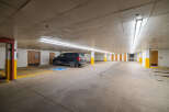 This spacious parking garage offers ample space for vehicles and features designated handicap parking.