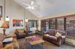 This cozy living room features a comfortable leather sofa and armchair, perfect for relaxing.