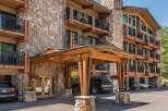 This stunning property boasts a beautiful stone facade and inviting balconies, perfect for enjoying the mountain views.