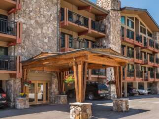 This stunning property boasts a beautiful stone facade and inviting balconies, perfect for enjoying the mountain views.