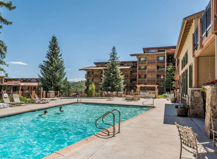 Enjoy a refreshing dip in the inviting outdoor pool, surrounded by stunning architecture and lush greenery.