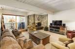 Step into a cozy living space featuring a stunning stone fireplace, perfect for those chilly evenings.