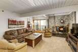 This cozy living room features a stunning stone fireplace, perfect for those chilly evenings.