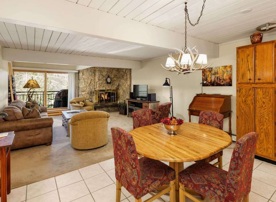 This stunning property boasts a cozy living room with a stone fireplace, perfect for chilly evenings.