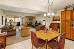 This stunning property boasts a cozy living room with a stone fireplace, perfect for chilly evenings.