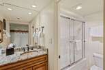 This stunning bathroom features a beautiful granite countertop and a stylish sink.