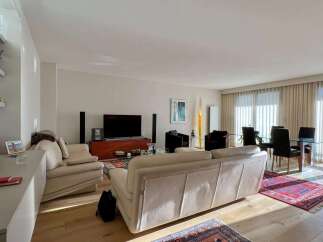 Experience luxury living in this stunning property, featuring a spacious living room with a modern design.