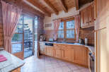 Step into this charming kitchen, featuring warm wooden cabinetry and a cozy atmosphere.