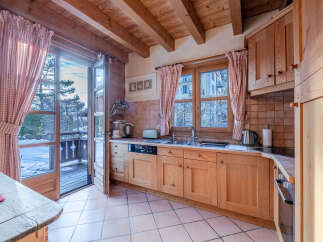 Step into this charming kitchen, featuring warm wooden cabinetry and a cozy atmosphere.