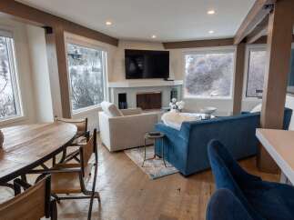 This stunning living space boasts a modern design with rustic accents, perfect for a cozy yet stylish home.