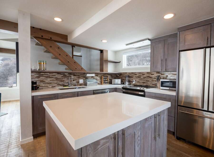 This stunning kitchen features a modern design with a spacious island, perfect for meal preparation and entertaining.