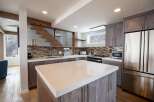 This stunning kitchen features a modern design with a spacious island, perfect for meal preparation and entertaining.