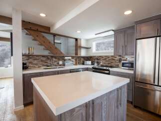 This stunning kitchen features a modern design with a spacious island, perfect for meal preparation and entertaining.