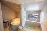 Indulge in luxury with this spa-like bathroom featuring a jacuzzi tub and a separate shower.